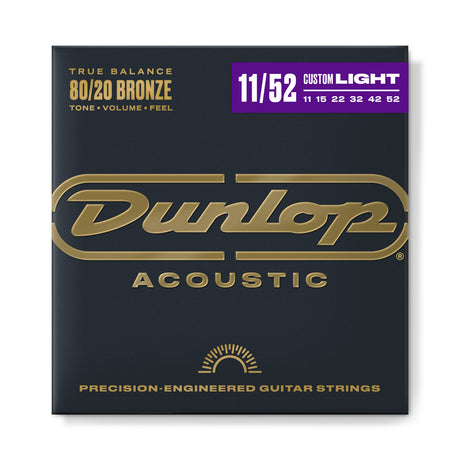 The image shows a package of Dunlop Acoustic guitar strings made with 80/20 Bronze for balanced tone, volume, and feel. It’s a Custom Light set (11-52 gauge) with precision-engineered strings (11, 15, 22, 32, 42, 52). The packaging features a dark charcoal background, gold Dunlop logo, and a purple accent bar highlighting the gauge, exuding a professional, premium look.