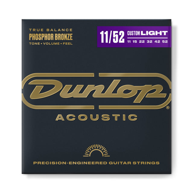 The image shows a package of Dunlop Acoustic guitar strings from the True Balance Phosphor Bronze series in Custom Light gauge (11-52). The packaging features Dunlop’s gold logo on a dark background with purple accents. It highlights precision-engineered phosphor bronze strings with gauges 11, 15, 22, 32, 42, and 52, promoting balanced tone, volume, and feel for acoustic guitars.