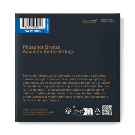 The image shows the back of a Dunlop Phosphor Bronze Acoustic Guitar Strings package, model DAP1356. It features the Dunlop logo and tagline, a barcode, and product details highlighting their "True Balance" design for even tone, consistent volume, and comfortable tension. Made in the USA by Dunlop Manufacturing, Inc., the strings are designed with artist feedback for optimal performance.