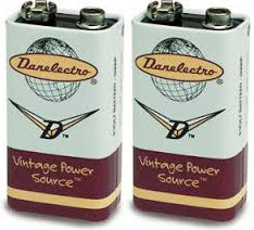 The image shows two identical Danelectro 9-volt batteries with vintage-style branding. Labeled "Vintage Power Source," they feature a mint green and burgundy retro design. These specialized batteries are designed for musical instruments like electric guitars and effects pedals, aligning with Danelectro’s nostalgic aesthetic and reputation for quality gear in the music industry.