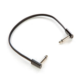 The image shows a guitar patch cable with 1/4-inch TS plugs—a straight connector on one end and a right-angled on the other. This short audio cable, featuring a black jacket and chrome connectors, is used to connect electric guitars or basses to amps, pedals, or audio interfaces and to link pedals in a setup. The right-angled plug helps save space and reduce strain on connections, making it essential for musicians.