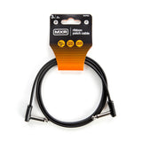 The image shows an MXR DCPR3 ribbon patch cable, a 3-inch (9 cm) black audio cable with right-angle connectors. It features flat, flexible design for easy cable management, ideal for connecting effects pedals and audio gear on pedalboards. The packaging is orange and black with badge icons highlighting product features, designed to save space and reduce cable stress in tight setups.