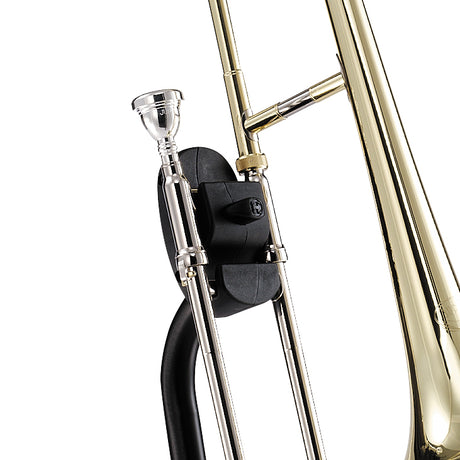 A close view of a gold trombone resting on a black trombone stand