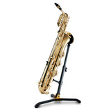 A gold baritone saxophone stand resting on a black saxophone stand on a white background