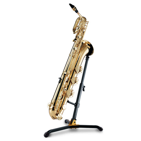 A gold baritone saxophone stand resting on a black saxophone stand on a white background