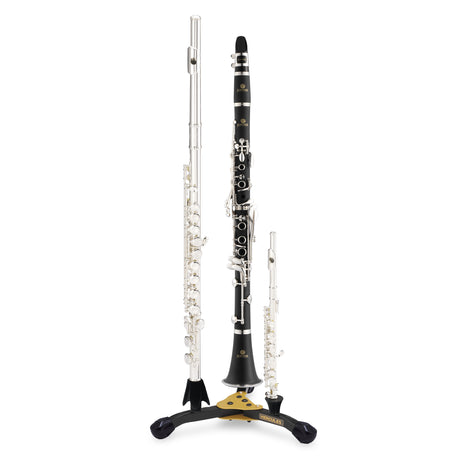 Three instruments - flute, clarinet, and piccolo resting on a black and yellow stand with Hercules branding