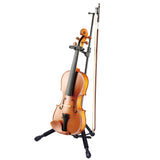 A violin resting on a black stand on a white background