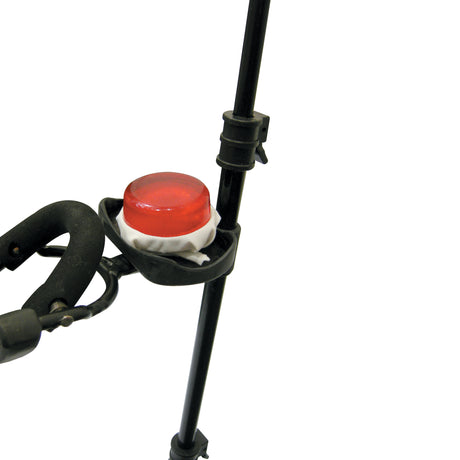 A close up view of a rosin cake resting on a holder on a violin stand