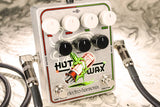 The image shows the Electro-Harmonix Hot Wax guitar pedal, a dual overdrive/distortion unit with two sets of white VOL and DRIVE knobs, three black BASS, TREBLE, and BLEND knobs, and a CRAYON switch. It features input/output jacks with 1/4" cables, a cream enclosure with colorful melting crayon graphics, and "HOT TUBES" text, designed for blending and stacking overdrive tones.