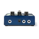 The image shows a blue guitar effects pedal with three black control knobs on top and three chrome input/output jacks on the front, including a central power input. The metal housing suggests a durable, high-quality design. This pedal is used by guitarists and bassists to modify their sound with effects like distortion, delay, or modulation, making it a key accessory for shaping tone in recording and live performances.