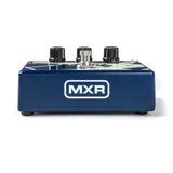 The image shows an MXR guitar effects pedal with a blue/navy metal housing and a white "MXR" logo on the front. It features two black control knobs, a central metal threaded jack, and a footswitch area. MXR is a well-known brand producing durable, high-quality analog and digital effects pedals used by guitarists to shape their sound in both live and studio settings.