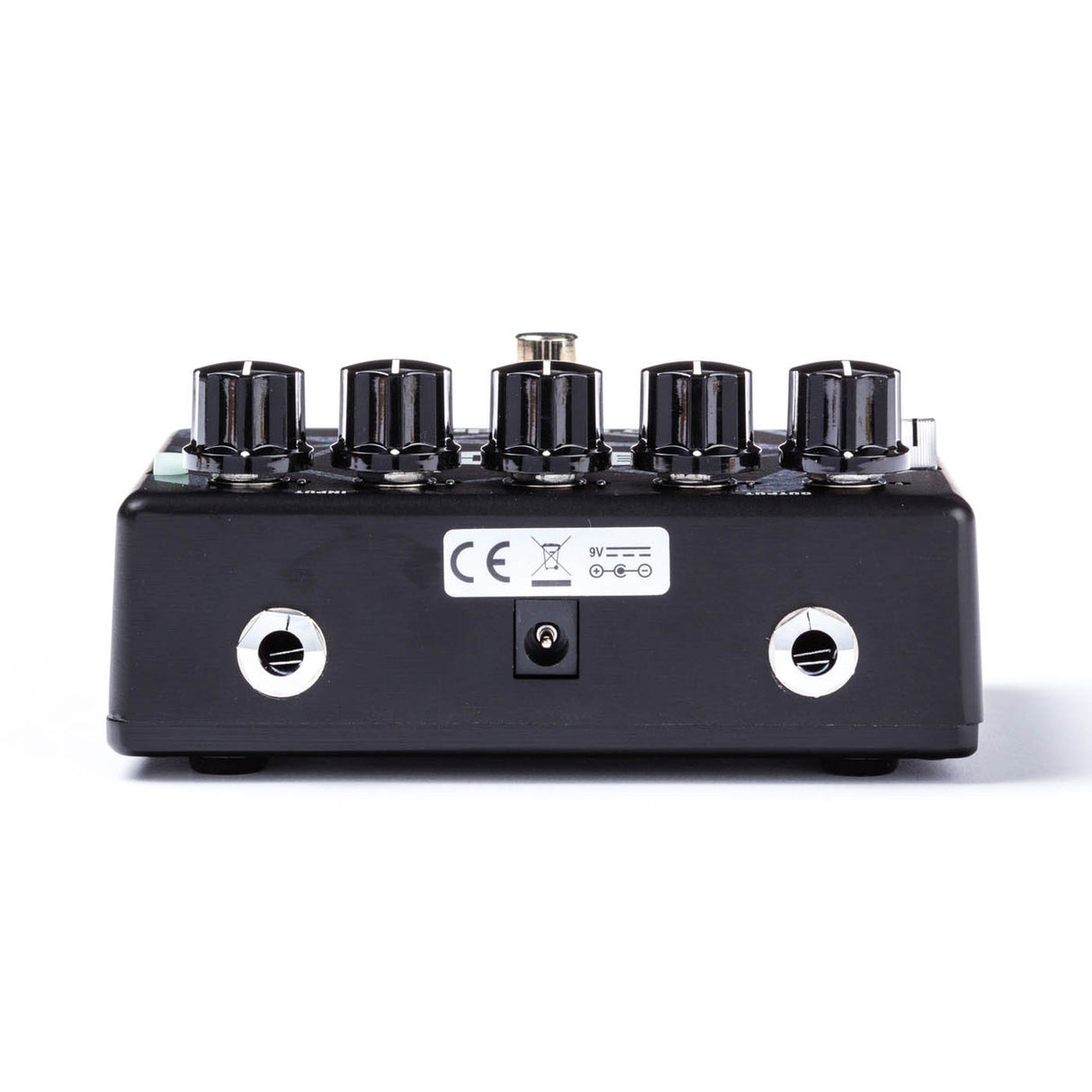 The image shows a black guitar effects pedal with five control knobs for adjusting gain, tone, and volume. It has two white input/output jacks, a 9V power input, and a CE mark. Designed for overdrive or distortion effects, this professional-grade pedal is used by guitarists to shape their sound, typically placed between the guitar and amplifier or on a pedalboard.