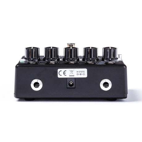 The image shows a black guitar effects pedal with five control knobs for adjusting gain, tone, and volume. It has two white input/output jacks, a 9V power input, and a CE mark. Designed for overdrive or distortion effects, this professional-grade pedal is used by guitarists to shape their sound, typically placed between the guitar and amplifier or on a pedalboard.