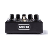 The image shows an MXR guitar effects pedal with a black metal housing and white MXR logo. It features five black control knobs, a gold-colored footswitch in the center, and a small toggle switch on the left. MXR pedals are popular stompboxes used by guitarists to modify electric guitar sounds, though the exact effect of this model is unclear from the image.
