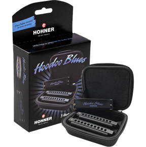 The image shows a Hohner "Hoodoo Blues" harmonica set, including a black retail box featuring the logo, "Free Online Lessons!" text, and mention of 3 harmonicas. An open black zippered carrying case displays three harmonicas in different keys for blues playing. Designed for beginners or intermediates, the set is ideal for exploring blues music with convenient portability.