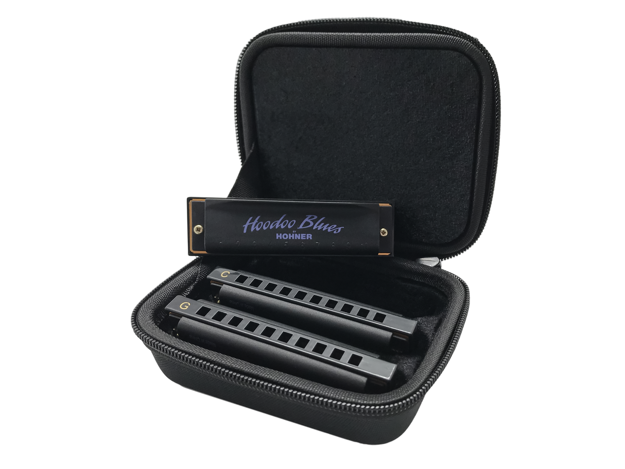 The image shows a Hohner "Hoodoo Blues" harmonica set featuring 2-3 harmonicas in different keys (including C and G) inside a black zippered carrying case with foam compartments. The case keeps the instruments organized and protected. Hohner is a well-known German brand, and this set is designed specifically for blues music, popular among musicians needing multiple keys in one portable kit.