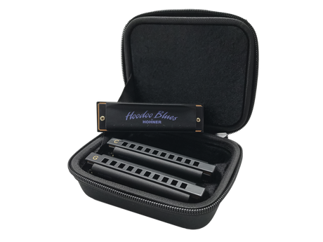 The image shows a Hohner "Hoodoo Blues" harmonica set featuring 2-3 harmonicas in different keys (including C and G) inside a black zippered carrying case with foam compartments. The case keeps the instruments organized and protected. Hohner is a well-known German brand, and this set is designed specifically for blues music, popular among musicians needing multiple keys in one portable kit.