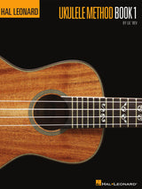 The image shows the cover of "Hal Leonard Ukulele Method Book 1" by Lil' Rev. It features a close-up of a wooden ukulele with decorative rope binding, an ornate sound hole rosette, part of the fretboard with fret markers, and four strings. Musical notation symbols appear over the fretboard. The background is black with orange-yellow text, displaying the Hal Leonard logo at the top and bottom. This is an instructional book for beginning ukulele players.