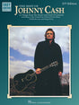The image shows the cover of "The Best of Johnny Cash" (2nd Edition) guitar songbook published by Hal Leonard. Part of the "Easy Guitar with Notes & Tab" series, it features 27 beginner to intermediate songs, including hits like "A Boy Named Sue," "Folsom Prison Blues," and "Ring of Fire." The cover depicts Johnny Cash in his signature black outfit holding a black acoustic guitar against a moody sky with bare trees.