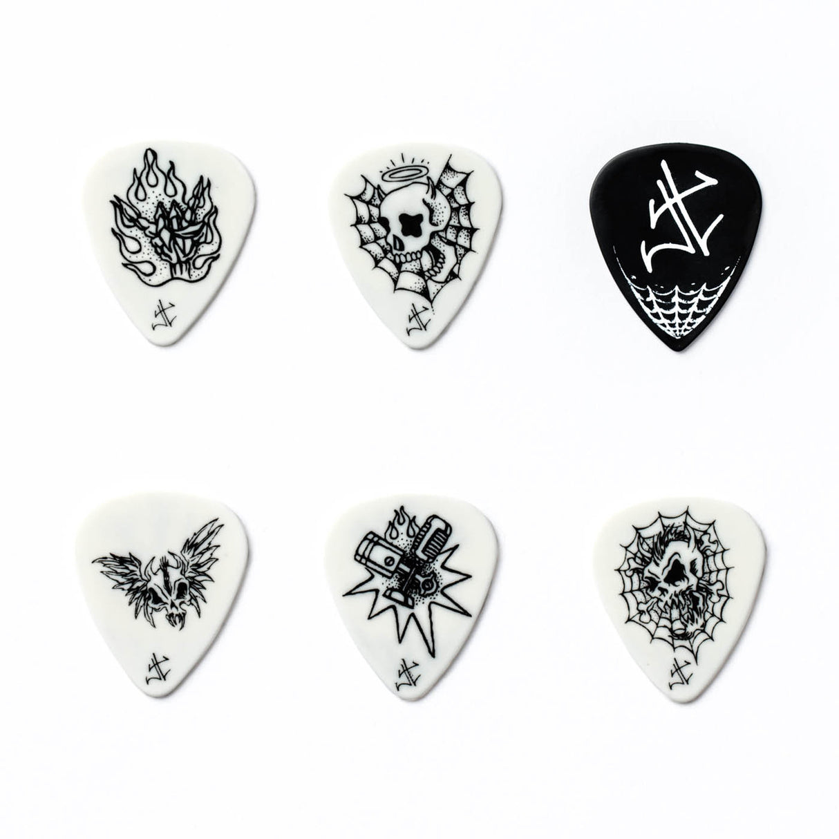 Set of six black and white guitar picks with various designs on a white background