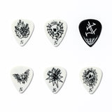 Set of six black and white guitar picks with various designs on a white background