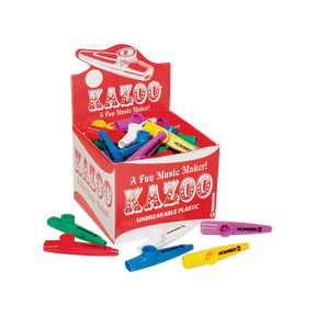 The image shows a retail display box of Hohner kazoos in bright colors like red, blue, yellow, green, purple, and white. The kazoos, made of unbreakable plastic, feature the tagline "A Fun Music Maker!" These beginner-friendly wind instruments create a buzzing sound when hummed and are popular for music education, casual play, and parties. Several kazoos are scattered around the box, highlighting their simple tube-like design.