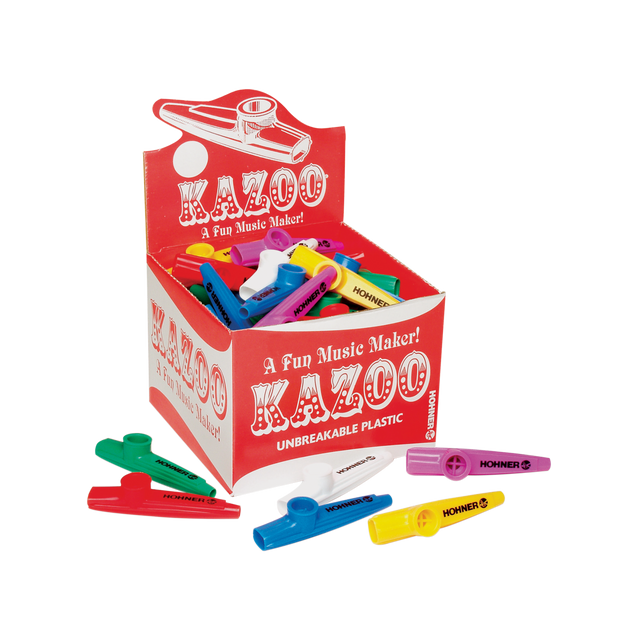 The image shows a retail display box of Hohner kazoos in bright colors like red, blue, yellow, green, purple, and white. The kazoos, made of unbreakable plastic, feature the tagline "A Fun Music Maker!" These beginner-friendly wind instruments create a buzzing sound when hummed and are popular for music education, casual play, and parties. Several kazoos are scattered around the box, highlighting their simple tube-like design.