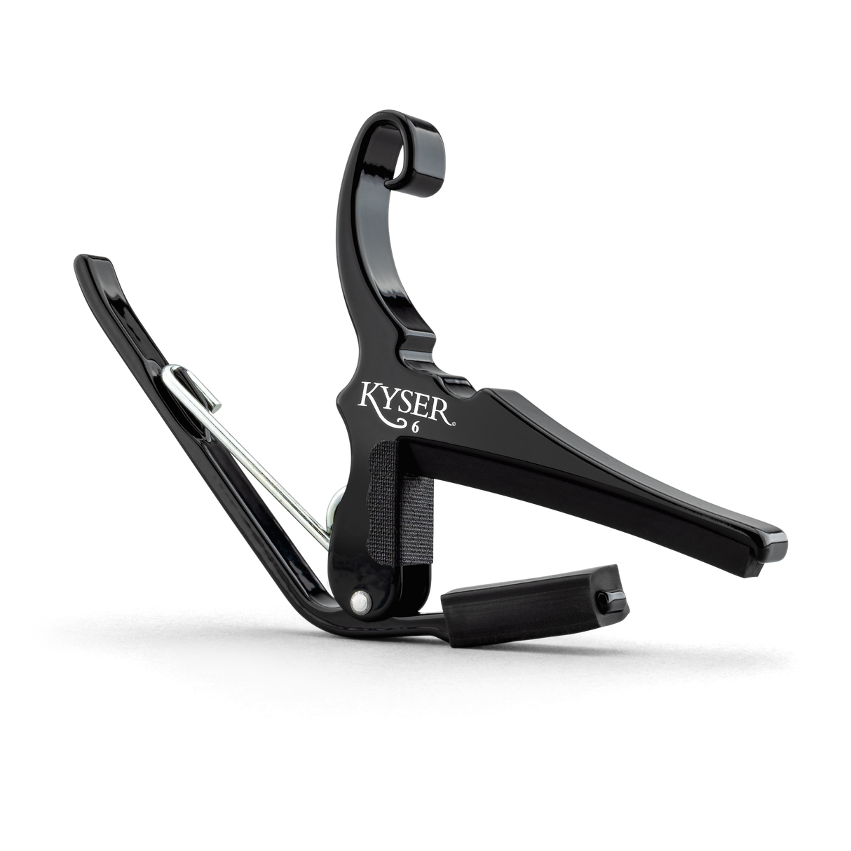 The image shows a Kyser guitar capo with a black finish and spring-loaded, quick-change design. This essential accessory clamps the fretboard to raise pitch, allowing guitarists to change keys easily, play in different vocal ranges, and create varied tones. The padded, curved arm ensures even pressure and protects the guitar neck. Kyser's capo is popular among musicians for its convenience and reliable performance.