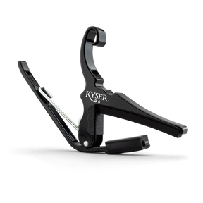 The image shows a Kyser guitar capo with a black finish and spring-loaded, quick-change design. This essential accessory clamps the fretboard to raise pitch, allowing guitarists to change keys easily, play in different vocal ranges, and create varied tones. The padded, curved arm ensures even pressure and protects the guitar neck. Kyser's capo is popular among musicians for its convenience and reliable performance.