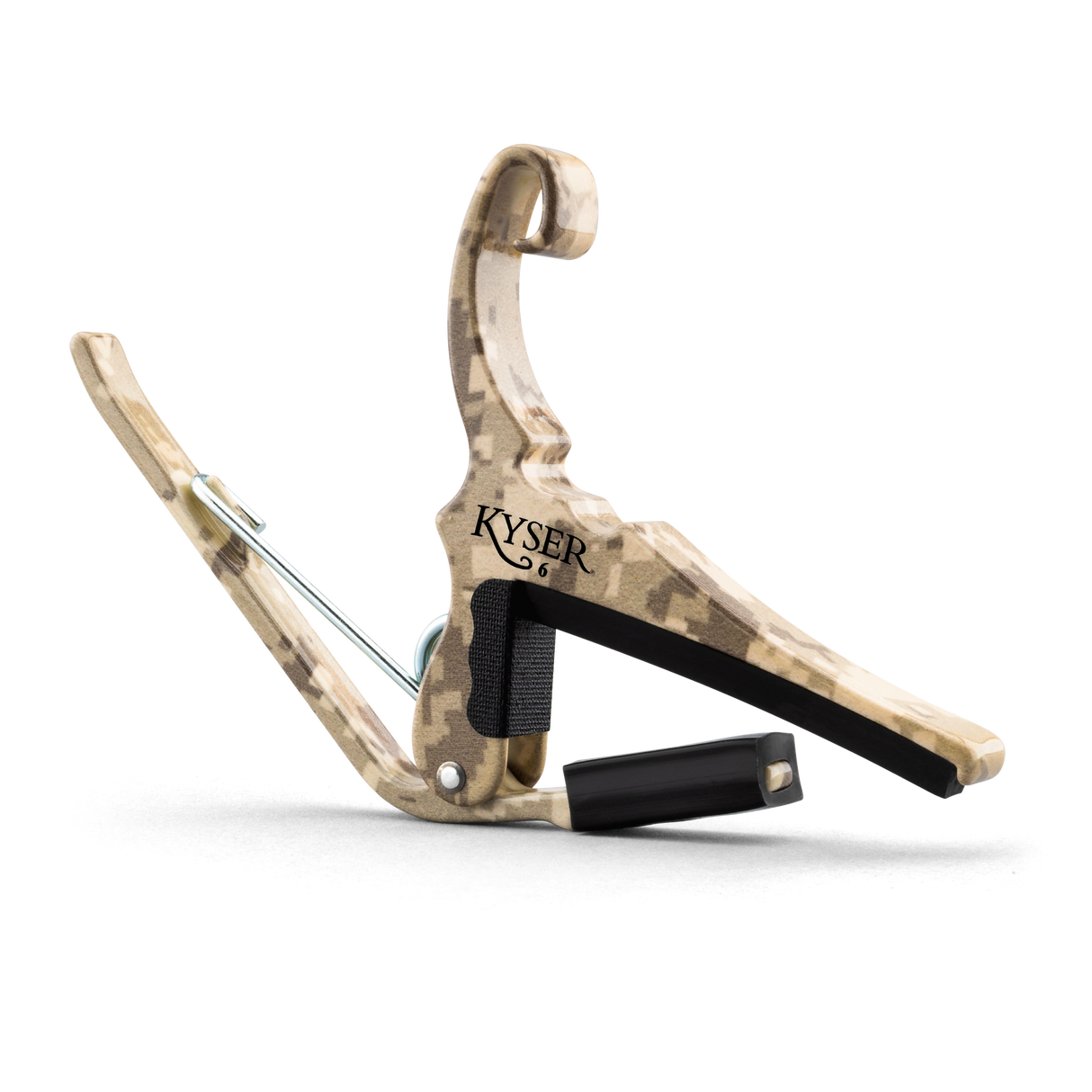 The image shows a Kyser Quick-Change guitar capo with a camouflage or wood-grain finish. It features a spring-loaded clamp with black padding to protect the fretboard and neck. The "KYSER" brand name is visible, and a black strap is attached for easy carrying. This popular accessory allows guitarists to quickly change pitch by clamping across the fretboard, enabling quick transposition with one-handed operation.