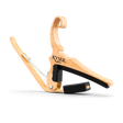 The image shows a Kyser guitar capo with a natural wooden finish. It features a spring-loaded, curved handle for one-handed use and black rubber padding to protect the fretboard and strings. The "KYSER" logo is visible, highlighting its brand. This ergonomic capo raises the pitch of all strings simultaneously, allowing guitarists to change keys easily while playing.