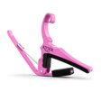 The image shows a bright pink Kyser guitar capo, a popular accessory that clamps across the fretboard to raise pitch and change keys easily. It features a spring-loaded mechanism for one-handed use, padded black contact surfaces to protect the guitar, and a curved design to fit the neck. Known for quick changes, Kyser capos are favored by guitarists seeking durability and convenience with a touch of personality.