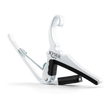 The image shows a white Kyser Quick-Change Capo, a spring-loaded clamp for guitar fretboards. It features a curved design with black rubber padding to protect the neck and frets. The capo allows easy one-handed use, enabling guitarists to change keys quickly while playing. Kyser is a popular brand known for its reliable, fast placement capo models favored by many guitarists.