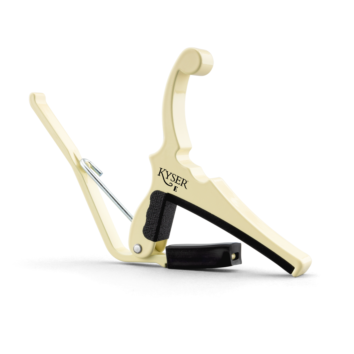 The image shows a Kyser Quick-Change guitar capo with a cream-colored metal body. It features a spring-loaded, lever-style mechanism for easy one-handed use, black rubber padding to protect the guitar, and a curved design to fit the neck. This accessory clamps across the fretboard to raise pitch, enabling guitarists to play in different keys while using familiar chord shapes.