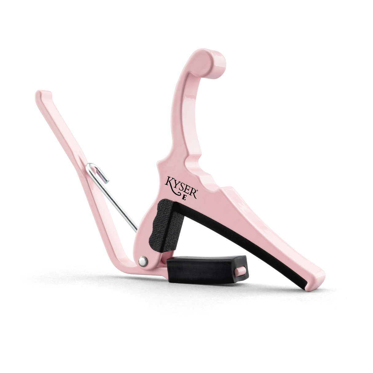 The image shows a pink Kyser guitar capo with a spring-loaded, curved handle for one-handed use. It features black rubber padding to protect the guitar neck, the "KYSER" logo on the clamp, and a sleek, ergonomic design typical of Kyser’s Quick-Change series. This capo, suitable for acoustic and electric guitars, allows players to change pitch easily while adding a stylish, personalized touch.