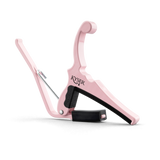 The image shows a pink Kyser guitar capo with a spring-loaded, curved handle for one-handed use. It features black rubber padding to protect the guitar neck, the "KYSER" logo on the clamp, and a sleek, ergonomic design typical of Kyser’s Quick-Change series. This capo, suitable for acoustic and electric guitars, allows players to change pitch easily while adding a stylish, personalized touch.