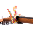 The image shows a Kyser spring-loaded clamp capo attached to the neck of an acoustic guitar. The capo features a vibrant, marbled pattern with swirls of pink, orange, yellow, and white, creating a colorful, tie-dye-like appearance. Part of the guitar’s wooden neck, fretboard, headstock, and tuning pegs are visible, highlighting both the capo’s functionality and eye-catching design.
