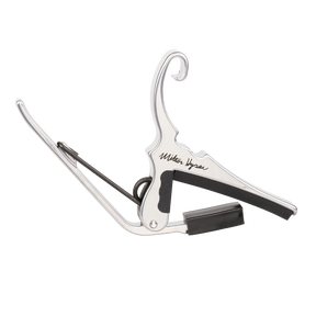 A silver Kyser capo with Milton Kyser signature on a white background