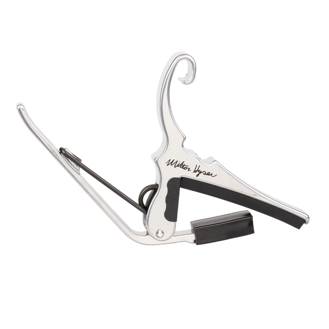 A silver Kyser capo with Milton Kyser signature on a white background