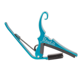 A teal Kyser guitar capo with 'Meredith' signature on a white background