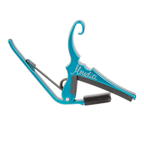 A teal Kyser guitar capo with 'Meredith' signature on a white background