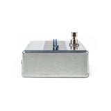 The image shows a guitar effects pedal with a compact, rectangular metal enclosure and a brushed aluminum or steel finish. It features a control knob on the right and a central switch or interface. These pedals are essential for electric guitarists and bassists to modify their sound with effects like distortion or delay. The durable metal build suits live and studio use, connecting between the guitar and amplifier or audio interface.