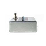 The image shows a kalimba, a traditional African thumb piano with a rectangular metal body and multiple metal tines arranged in a row. It features a brushed aluminum or stainless steel finish and an output jack on the left side, indicating it is an electric or amplified model. The tines are tuned to produce melodic, ethereal sounds, commonly used in world, ambient, and contemporary music.