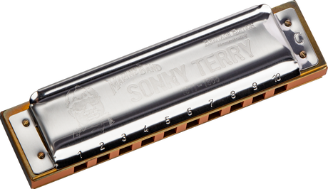 The image shows a Hohner Marine Band harmonica with a chrome top plate featuring "Marine Band" and "SOLITARY" engravings. It has a natural wooden comb, numbered holes 1-10, and the classic rectangular shape of a 10-hole diatonic harmonica. This wind instrument is played by blowing air through the holes to produce notes and is popular in blues, folk, and rock music.