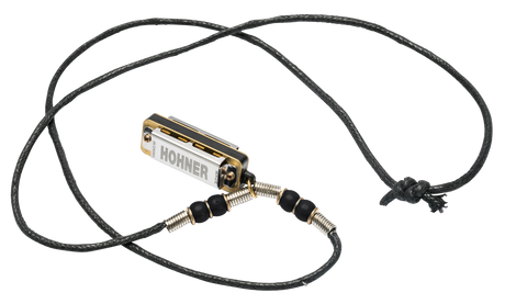 The image shows a Hohner brand harmonica necklace featuring a small, 10-hole diatonic harmonica mounted on an adjustable black braided cord. The harmonica is attached with a metal spring or coiled wire connector decorated with beads. This wearable design is popular among folk, blues, and street musicians, allowing hands-free play and easy access while performing with other instruments.