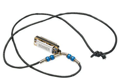 The image shows a compact Hohner harmonica with chrome and gold coloring, attached to a black braided cord necklace. Blue beads and metal coil springs decorate the cord on either side, adding grip and style. This wearable setup allows easy, hands-free access, popular among folk musicians and street performers. Hohner is a renowned German brand known for high-quality harmonicas.