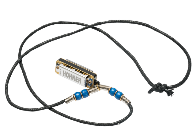 The image shows a compact Hohner harmonica with chrome and gold coloring, attached to a black braided cord necklace. Blue beads and metal coil springs decorate the cord on either side, adding grip and style. This wearable setup allows easy, hands-free access, popular among folk musicians and street performers. Hohner is a renowned German brand known for high-quality harmonicas.