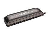 The image shows a Hohner Super 64 Performance chromatic harmonica with a sleek black/dark gray finish. It features a chrome-plated slide button on the right, 12 numbered holes, and "Made in Germany" marking. This professional-quality instrument allows full chromatic play, suitable for various musical styles requiring complex harmonics.