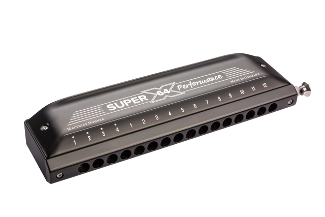 The image shows a Hohner Super 64 Performance chromatic harmonica with a sleek black/dark gray finish. It features a chrome-plated slide button on the right, 12 numbered holes, and "Made in Germany" marking. This professional-quality instrument allows full chromatic play, suitable for various musical styles requiring complex harmonics.