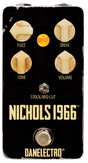 The image shows a Danelectro "Nichols 1966" guitar effects pedal. This compact black pedal has a vintage 1960s design and features four cream-colored knobs labeled Fuzz, Drive, Tone, and Volume. It includes a toggle switch for "Stock/Mid Cut" tonal options and a footswitch at the bottom. The worn finish adds to its retro look. The pedal recreates classic 60s fuzz and overdrive tones, ideal for vintage-style guitar sounds.